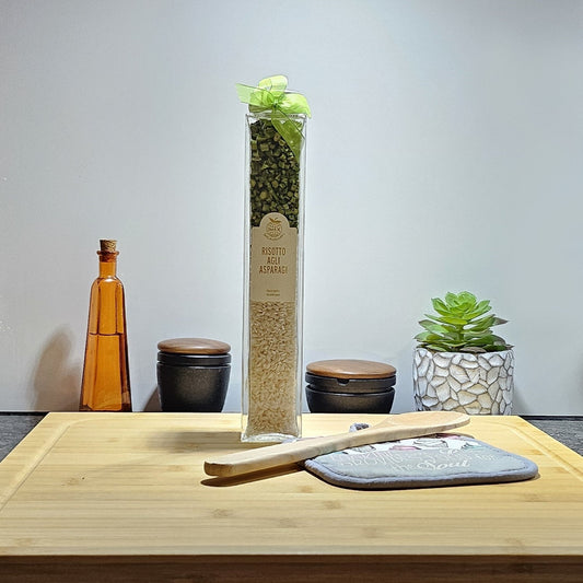 Spargelrisotto im Geschenkglas in der Küche mit einem Holzlöffel auf einem Holzbrett