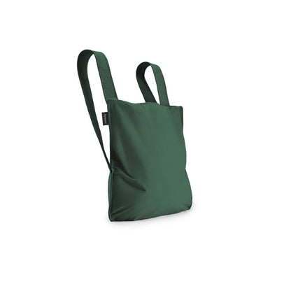 Dunkelgrüne Notabag – wandelbare Tasche und Rucksack, leicht, faltbar und nachhaltig für Alltag und Stadt.