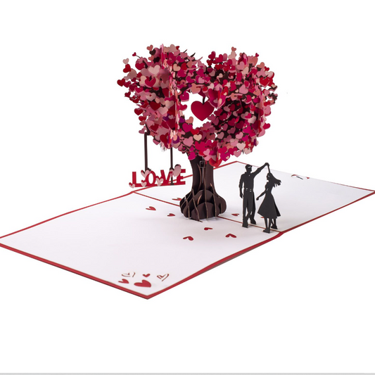 Pop-up-Grußkarte, die beim Öffnen einen Herzbaum und ein tanzendes Paar zeigt