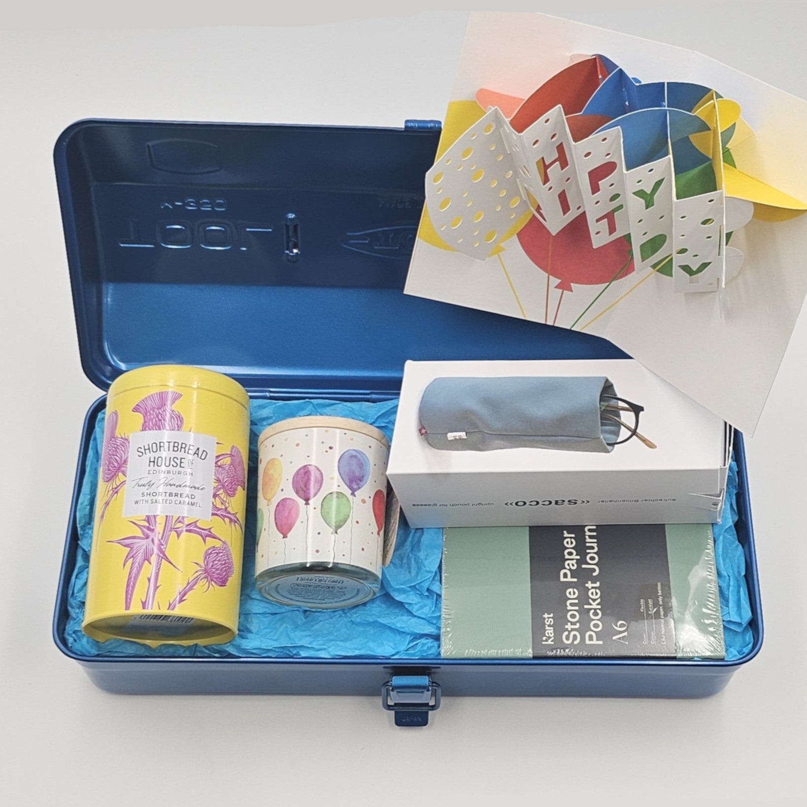 Blaue Geschenkbox gefüllt mit Happy Birthday Produkten