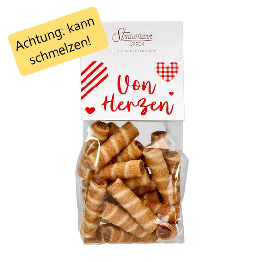 Zarte Schweizer Hüppen mit knusprigen Waffelröllchen und cremiger Haselnuss-Gianduja-Füllung in Geschenkverpackung
